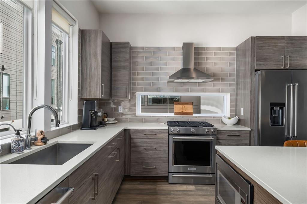 52 Reynolds Square Lane Atlanta, GA 30307 - Photo 4 of 32 a kitchen with stainless steel appliances granite countertop a stove and a sink