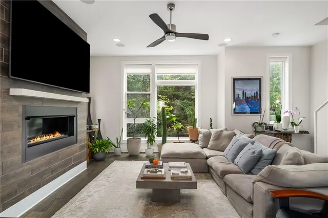 a living room with furniture a flat screen tv and a fireplace