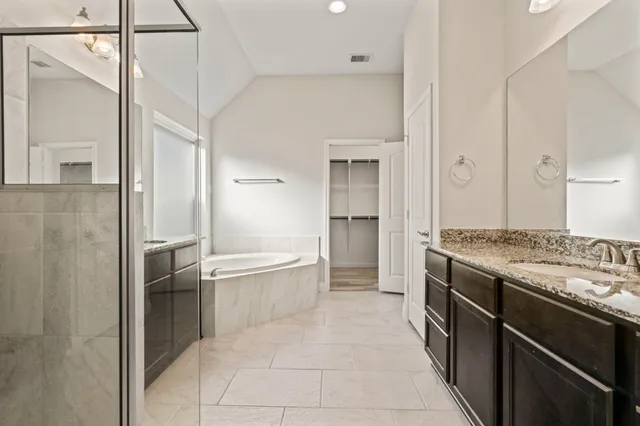 a bathroom with a bathtub and a shower