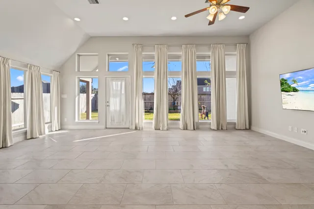 a kitchen with kitchen island granite countertop a refrigerator and a sink