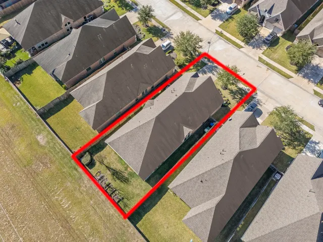 an aerial view of residential building and parking space