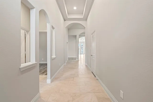 a view of a hallway with wooden floor and entryway