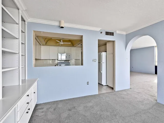 a room with a large window and bed