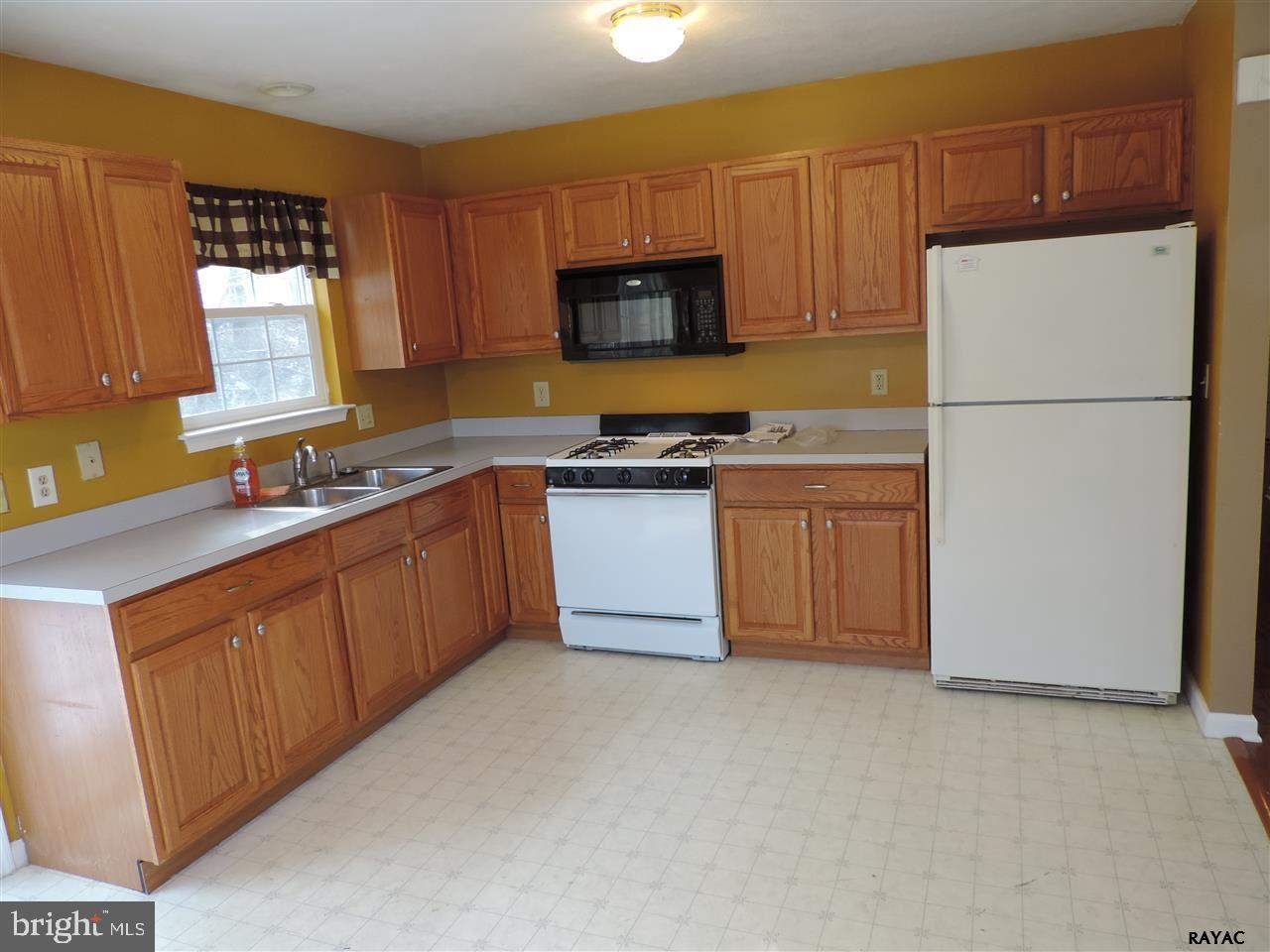 295 Elfner Road Red Lion, PA 17356 - Photo 11 of 27 a kitchen with stainless steel appliances granite countertop a stove a sink dishwasher a refrigerator and a microwave