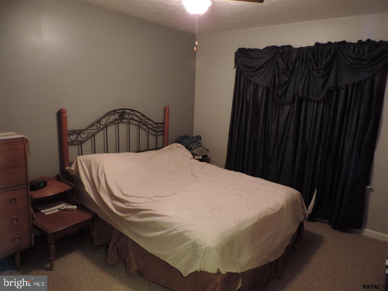 295 Elfner Road Red Lion, PA 17356 - Photo 12 of 27 a bed sitting in a bedroom with wooden floor
