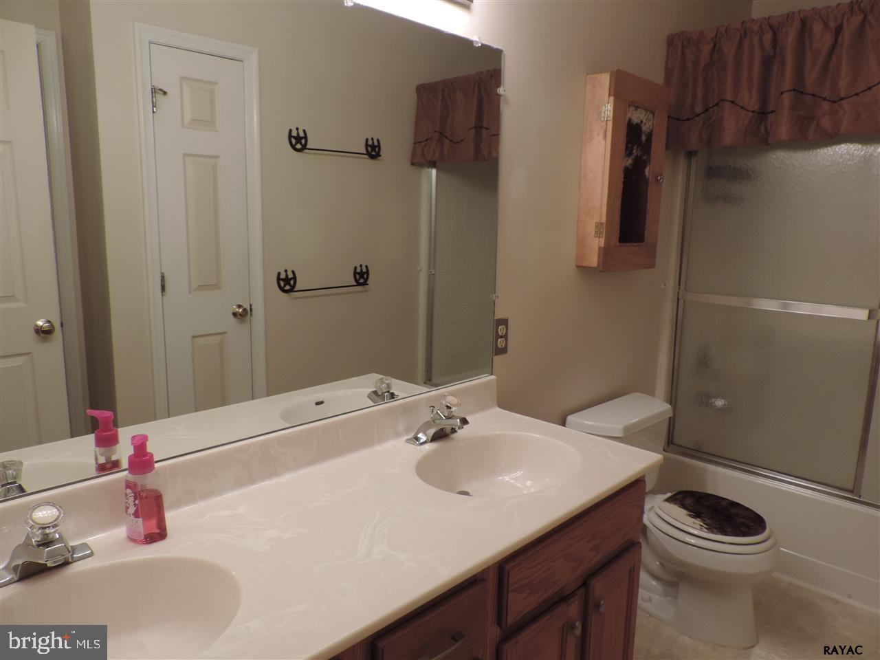 295 Elfner Road Red Lion, PA 17356 - Photo 14 of 27 a bathroom with a sink and a mirror