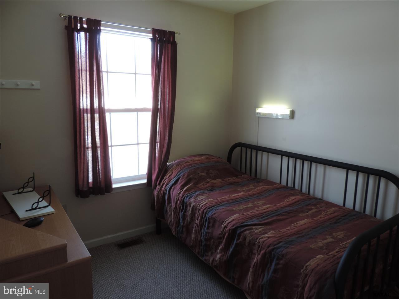 295 Elfner Road Red Lion, PA 17356 - Photo 17 of 27 a bed sitting in a bedroom next to a window