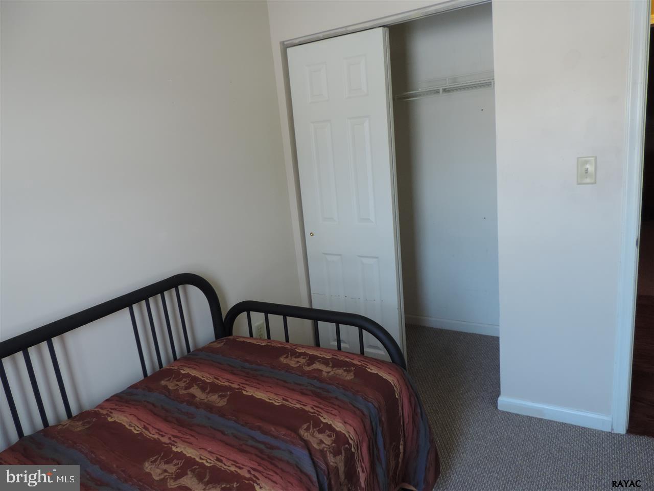 295 Elfner Road Red Lion, PA 17356 - Photo 18 of 27 a bedroom with a bed and wooden floor