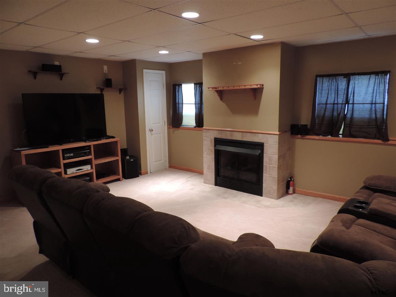 295 Elfner Road Red Lion, PA 17356 - Photo 19 of 27 a living room with furniture and a flat screen tv