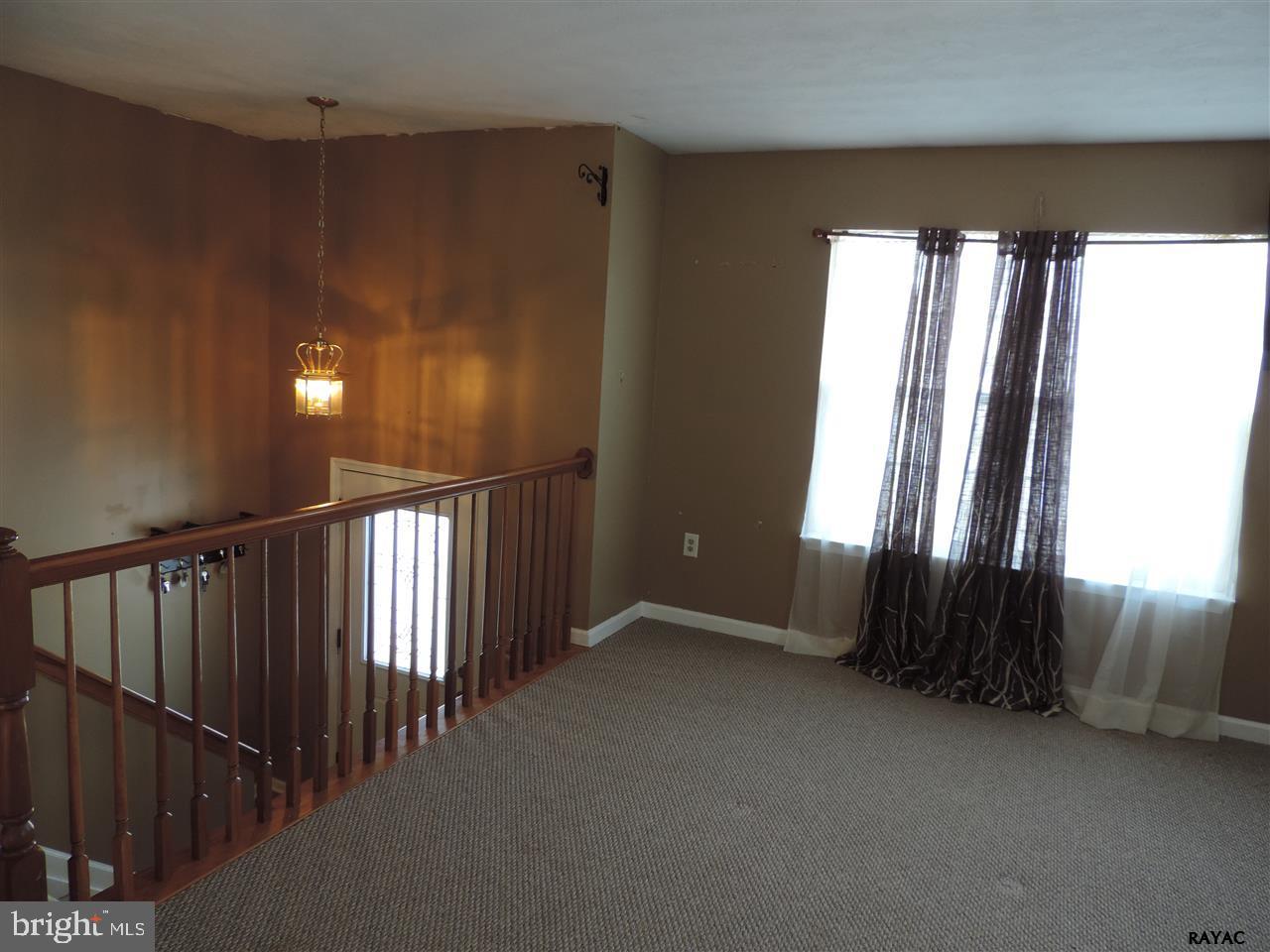 295 Elfner Road Red Lion, PA 17356 - Photo 6 of 27 en empty room with windows and stairs
