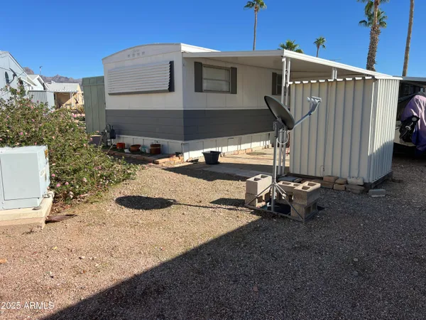 a backyard of a house with barbeque oven