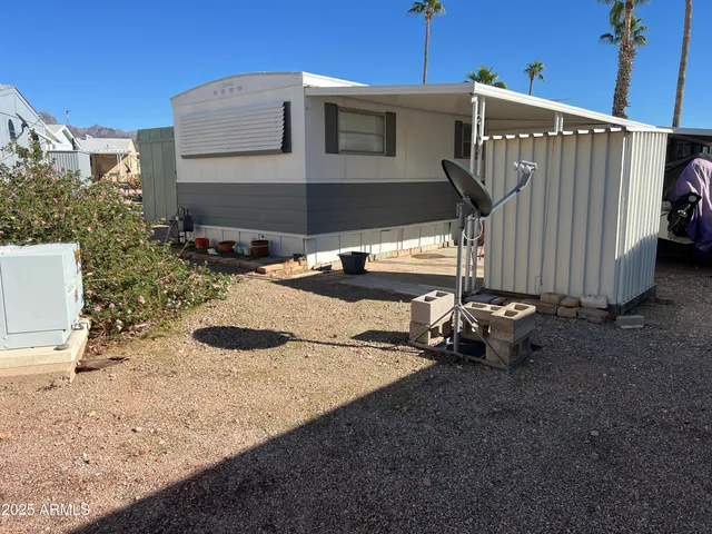 a backyard of a house with barbeque oven
