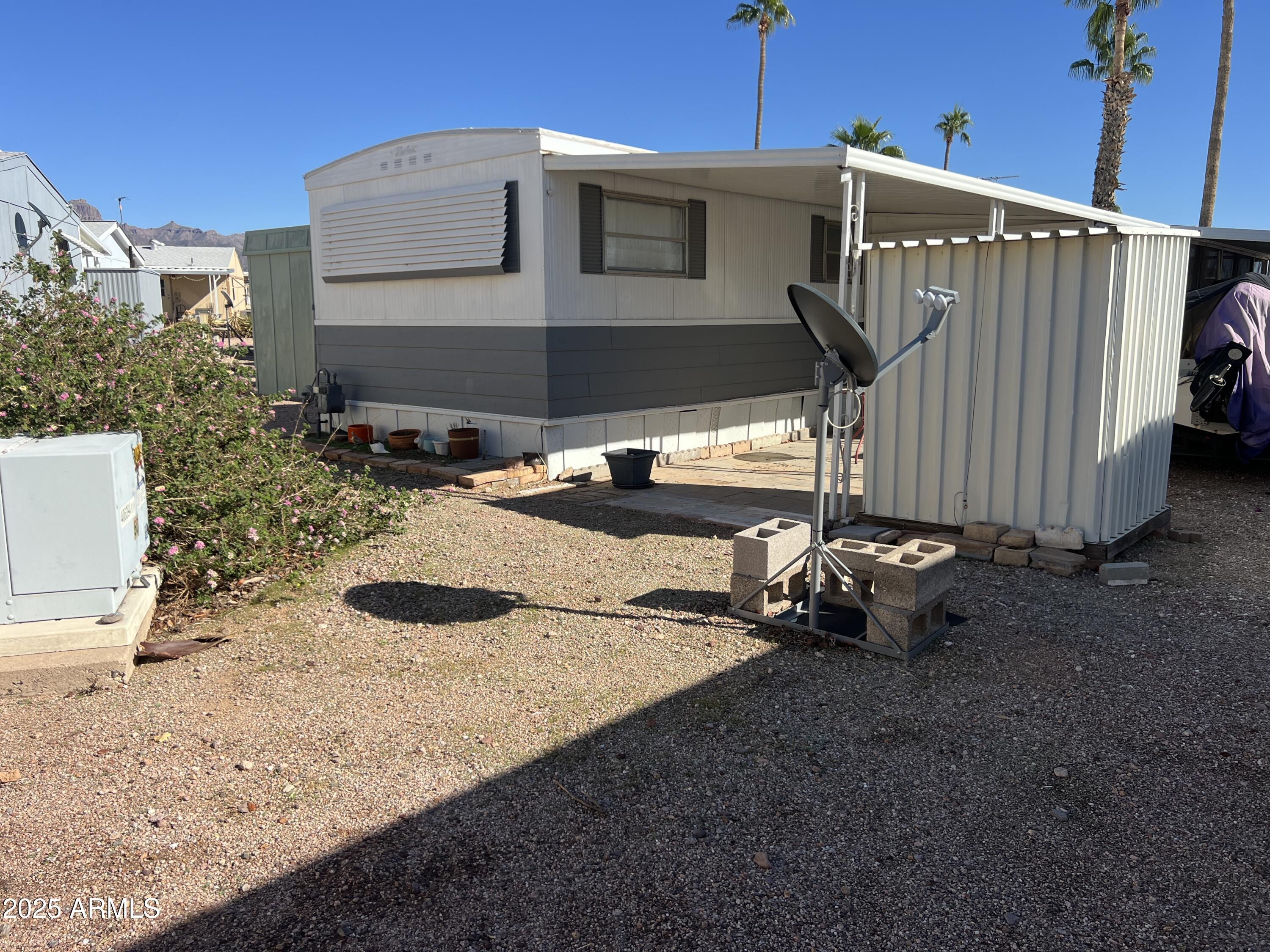 269 North Winchester Road, Unit 7 Apache Junction, AZ 85119 - Photo 16 of 26 a backyard of a house with barbeque oven