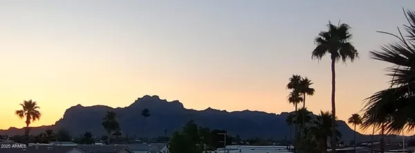 a view of ocean and a mountain in the background
