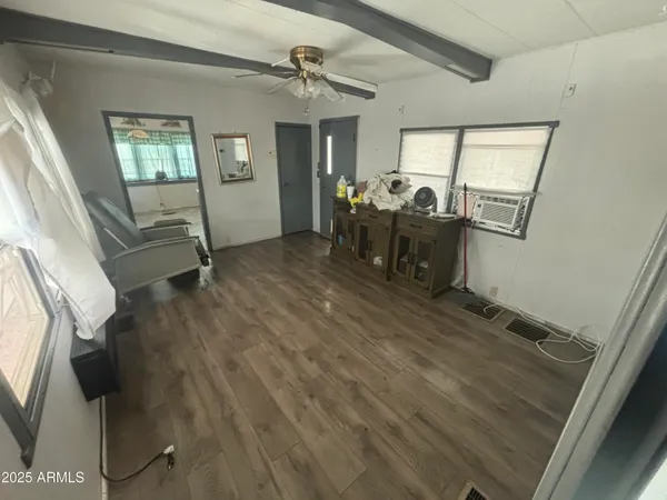 a view of a livingroom with furniture and a window