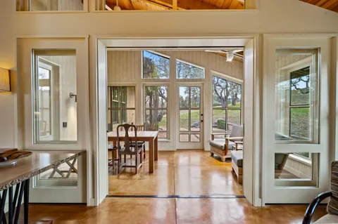 a dining room with furniture and a window