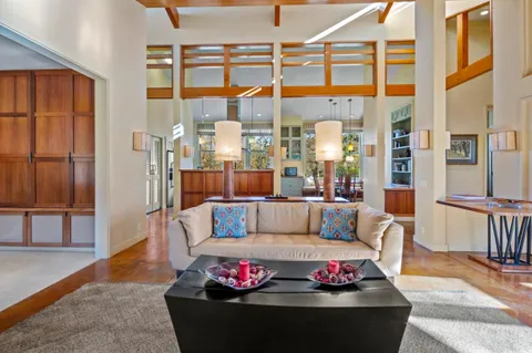 a living room with furniture a rug and a large window