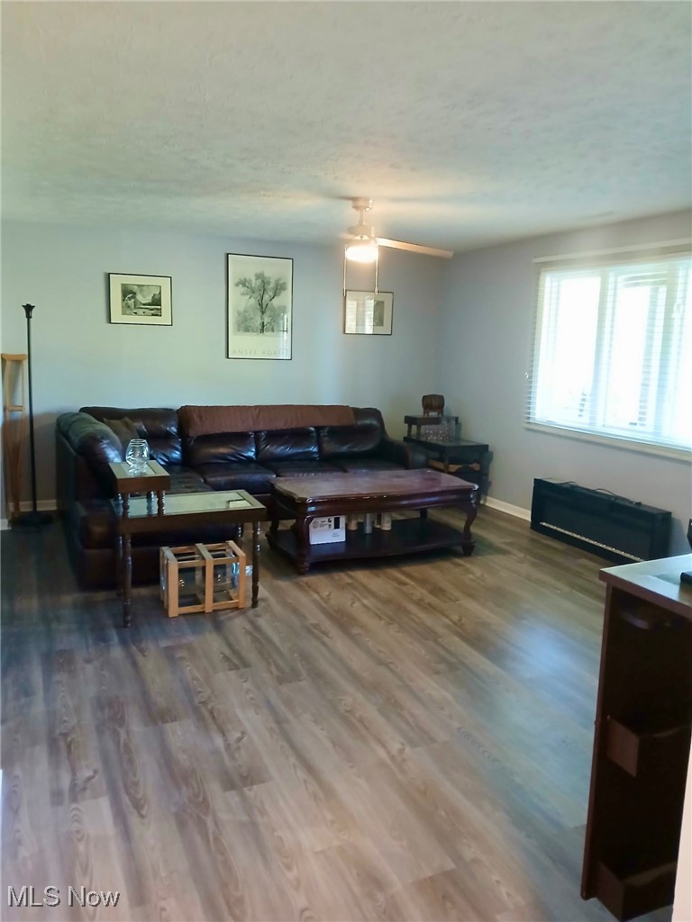1685 Fattler Ridge Road Philo, OH 43771 - Photo 19 of 24 Living area with dark wood finished floors, a ceiling fan, and a textured ceiling