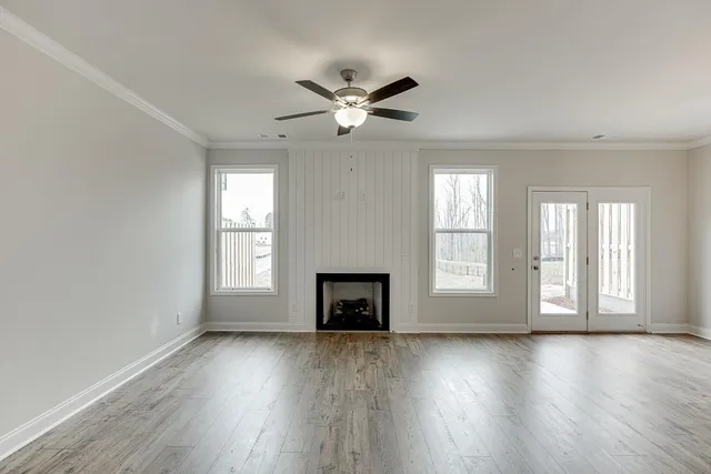 a view of kitchen with kitchen island white cabinets and wooden floor