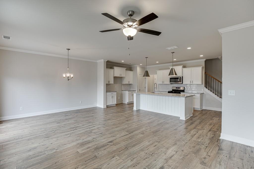 763 Woods Chapel Road Sugar Hill, GA 30518 - Photo 17 of 67 a view of kitchen with kitchen island white cabinets and wooden floor