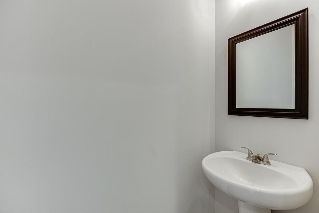 763 Woods Chapel Road Sugar Hill, GA 30518 - Photo 18 of 67 a bathroom with a sink and a mirror