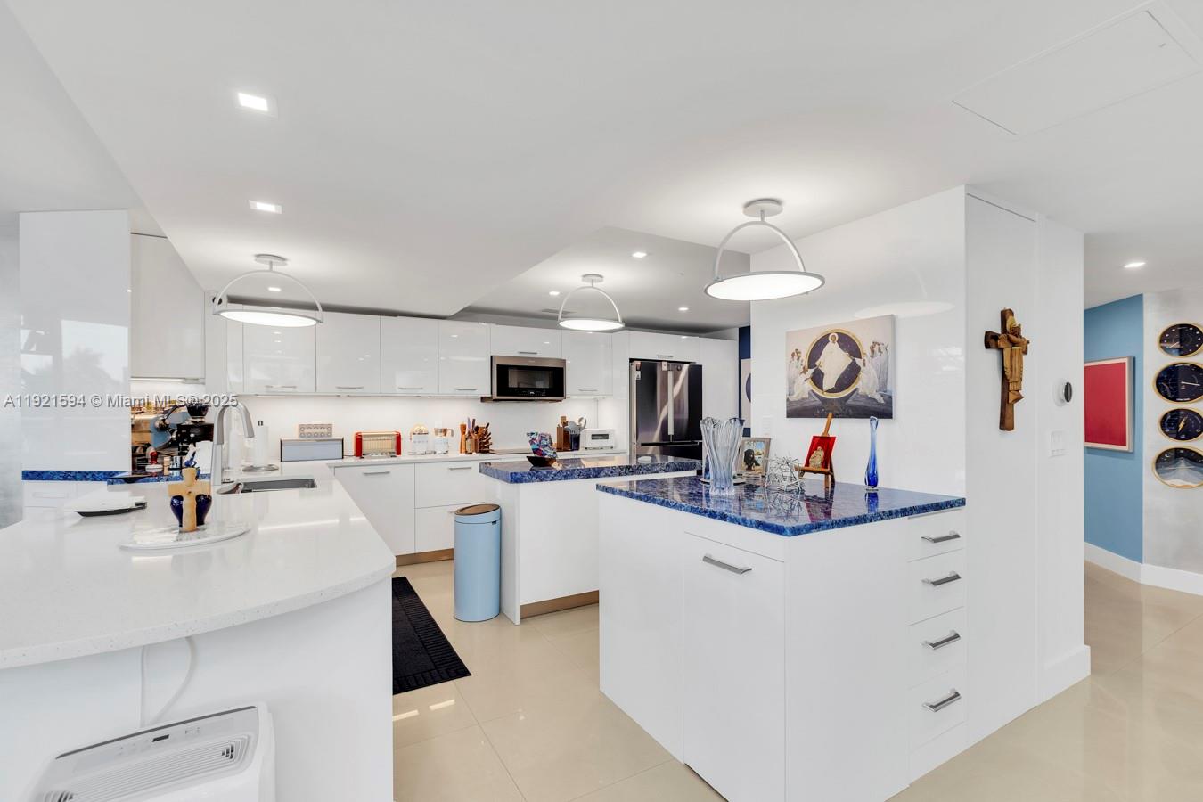3131 Northeast 188th Street, Unit 2301 Aventura, FL 33180 - Photo 13 of 73 a kitchen with counter top space cabinets and stainless steel appliances