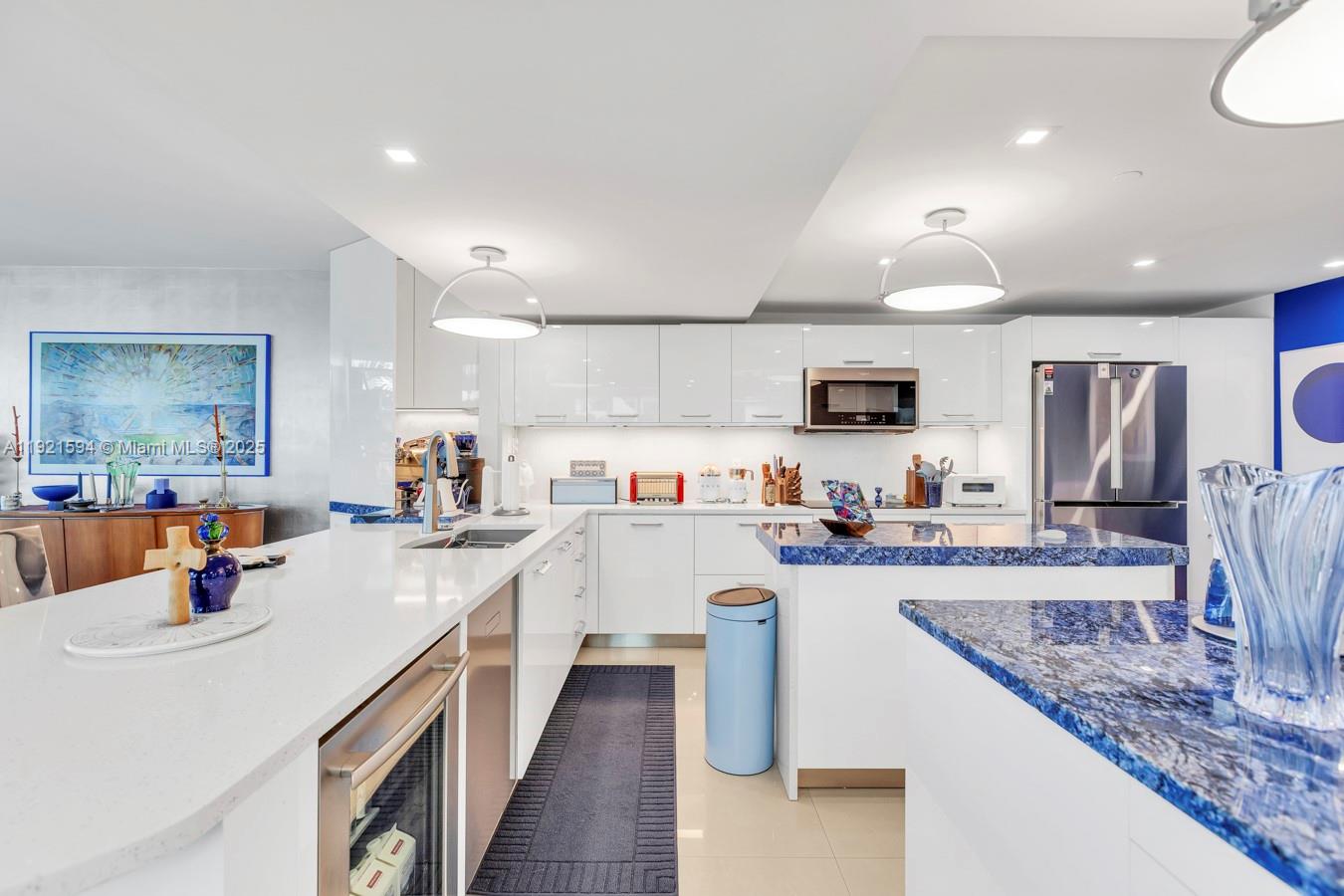 3131 Northeast 188th Street, Unit 2301 Aventura, FL 33180 - Photo 14 of 73 a kitchen with a sink a counter top space stainless steel appliances and cabinets