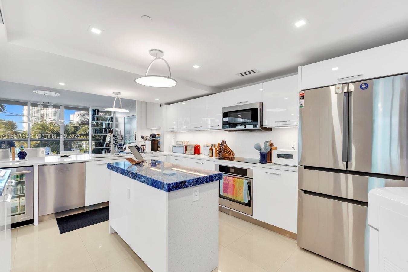 3131 Northeast 188th Street, Unit 2301 Aventura, FL 33180 - Photo 15 of 73 a kitchen with appliances a sink and a refrigerator