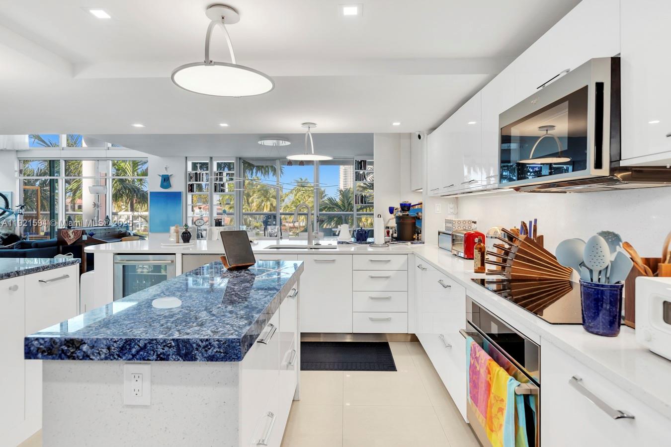 3131 Northeast 188th Street, Unit 2301 Aventura, FL 33180 - Photo 16 of 73 a kitchen with stainless steel appliances granite countertop a sink and a white cabinets