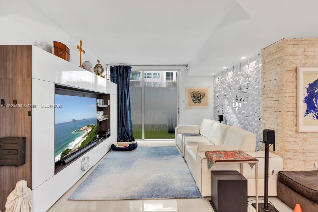 3131 Northeast 188th Street, Unit 2301 Aventura, FL 33180 - Photo 17 of 73 a living room with furniture a flat screen tv and a fireplace