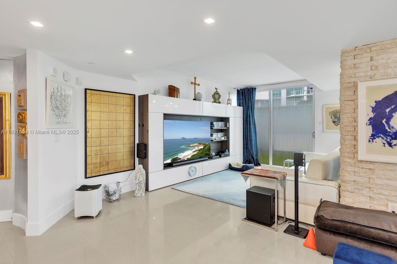 3131 Northeast 188th Street, Unit 2301 Aventura, FL 33180 - Photo 18 of 73 a living room with furniture and a flat screen tv