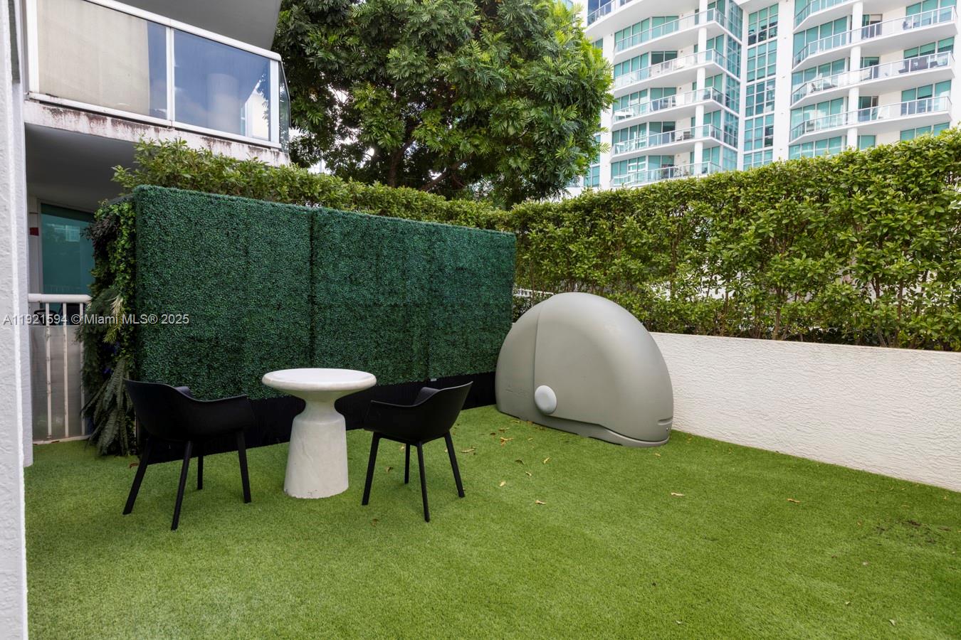 3131 Northeast 188th Street, Unit 2301 Aventura, FL 33180 - Photo 19 of 73 a view of a table and chairs in patio