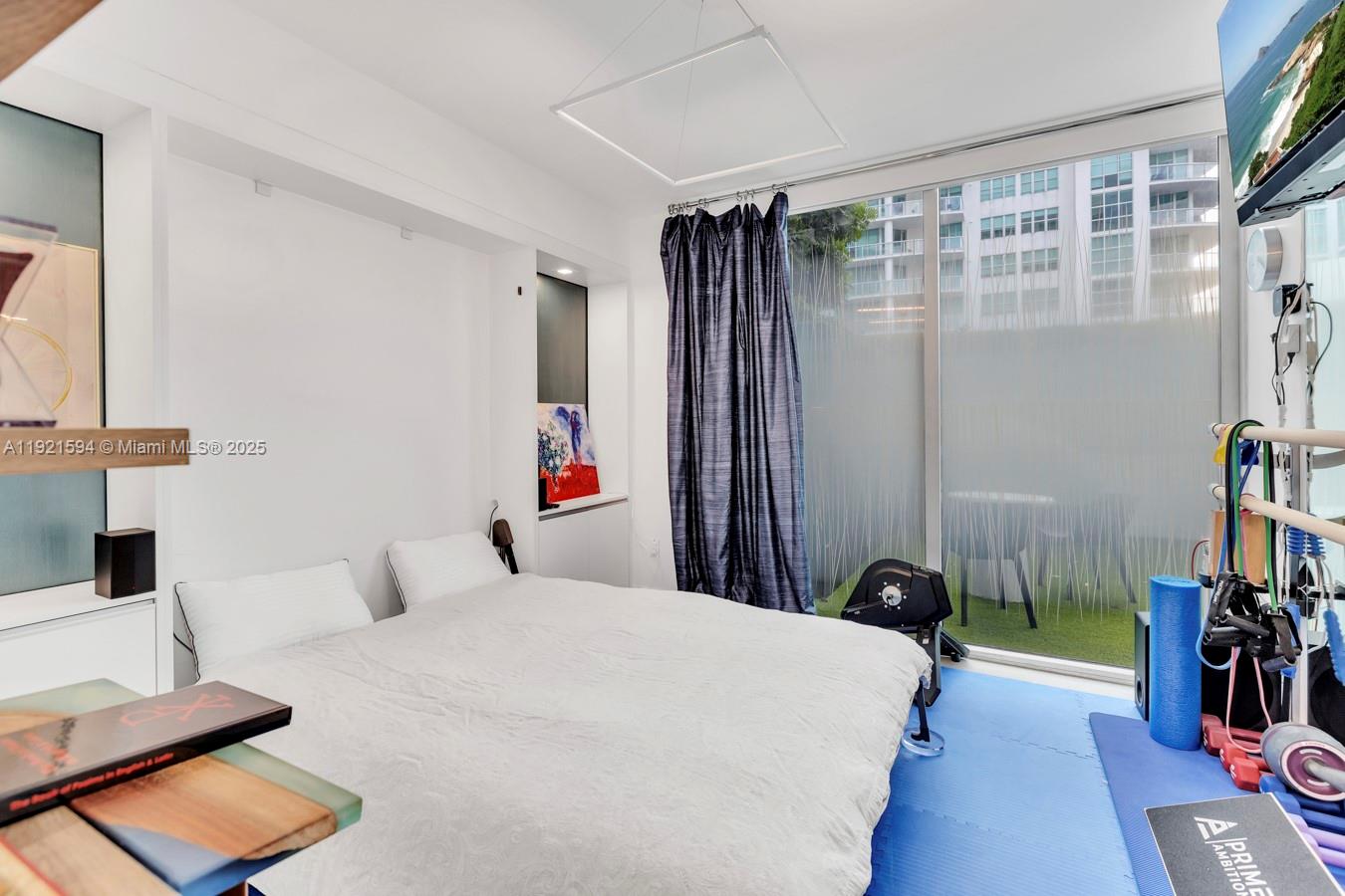 3131 Northeast 188th Street, Unit 2301 Aventura, FL 33180 - Photo 25 of 73 a bedroom with a bed and a book shelf