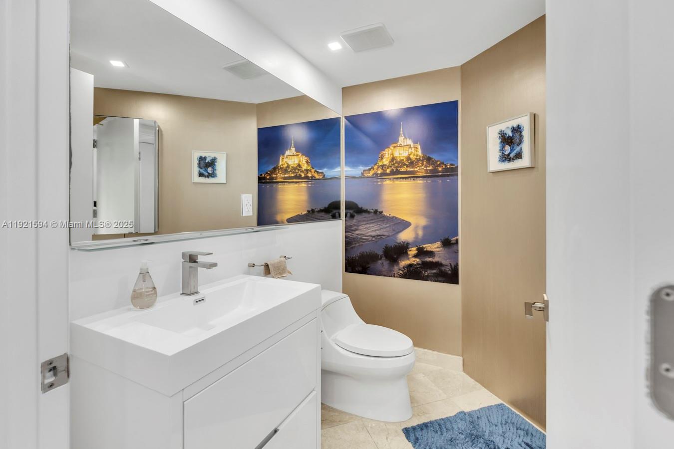 3131 Northeast 188th Street, Unit 2301 Aventura, FL 33180 - Photo 27 of 73 a bathroom with a sink toilet and mirror