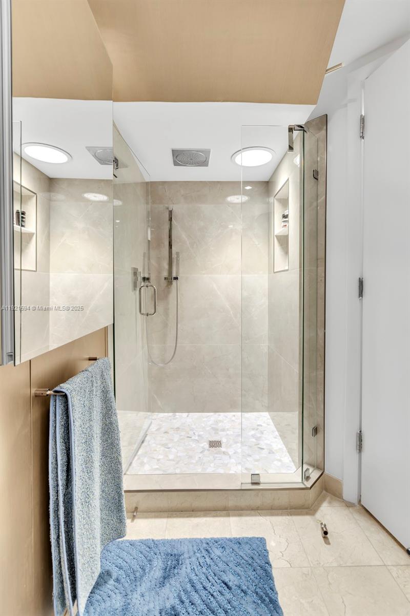 3131 Northeast 188th Street, Unit 2301 Aventura, FL 33180 - Photo 28 of 73 a bathroom with a glass shower door