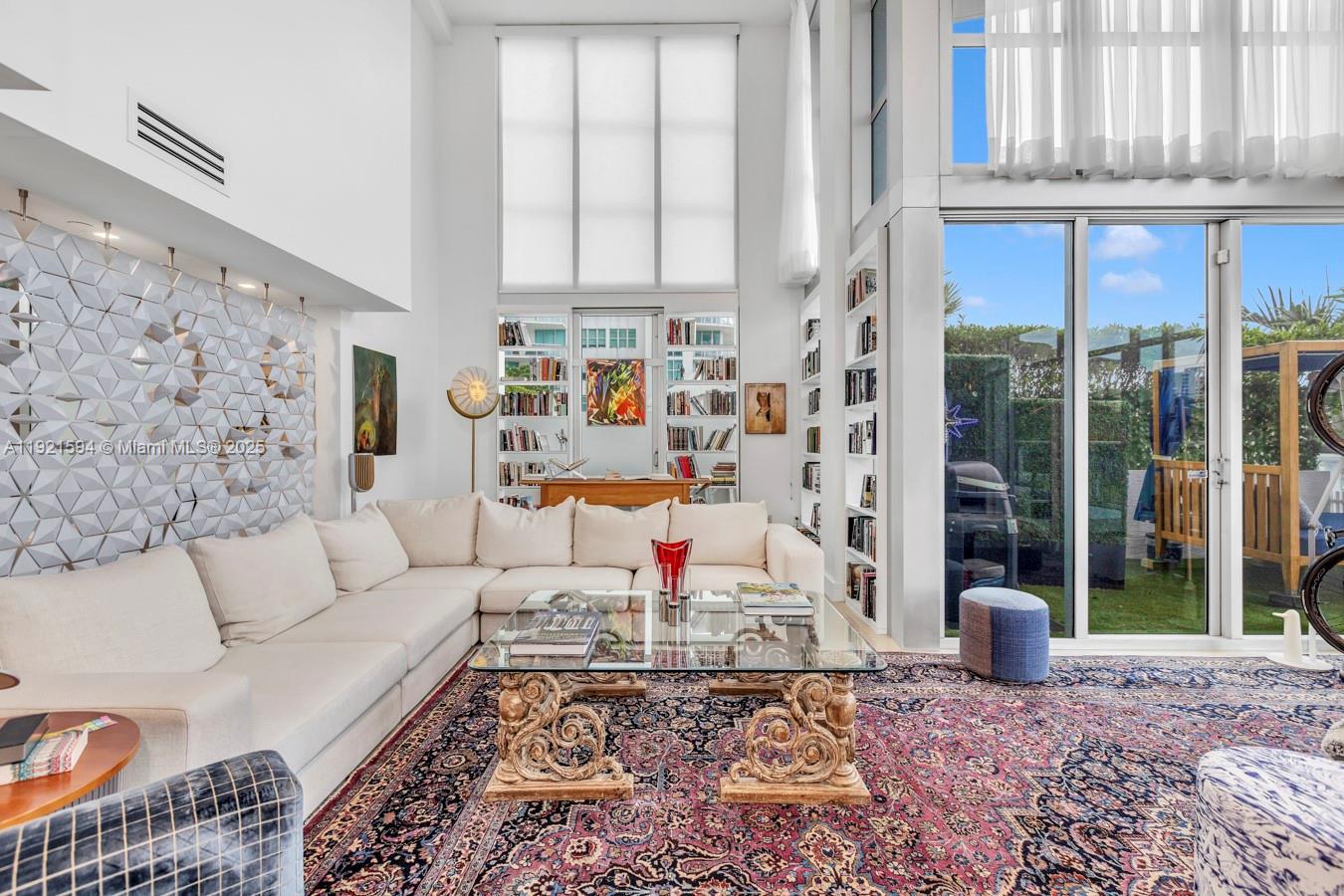 3131 Northeast 188th Street, Unit 2301 Aventura, FL 33180 - Photo 3 of 73 a living room with furniture and a floor to ceiling window