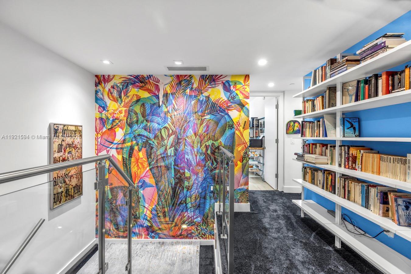 3131 Northeast 188th Street, Unit 2301 Aventura, FL 33180 - Photo 31 of 73 a living room with lots of books and a book shelf