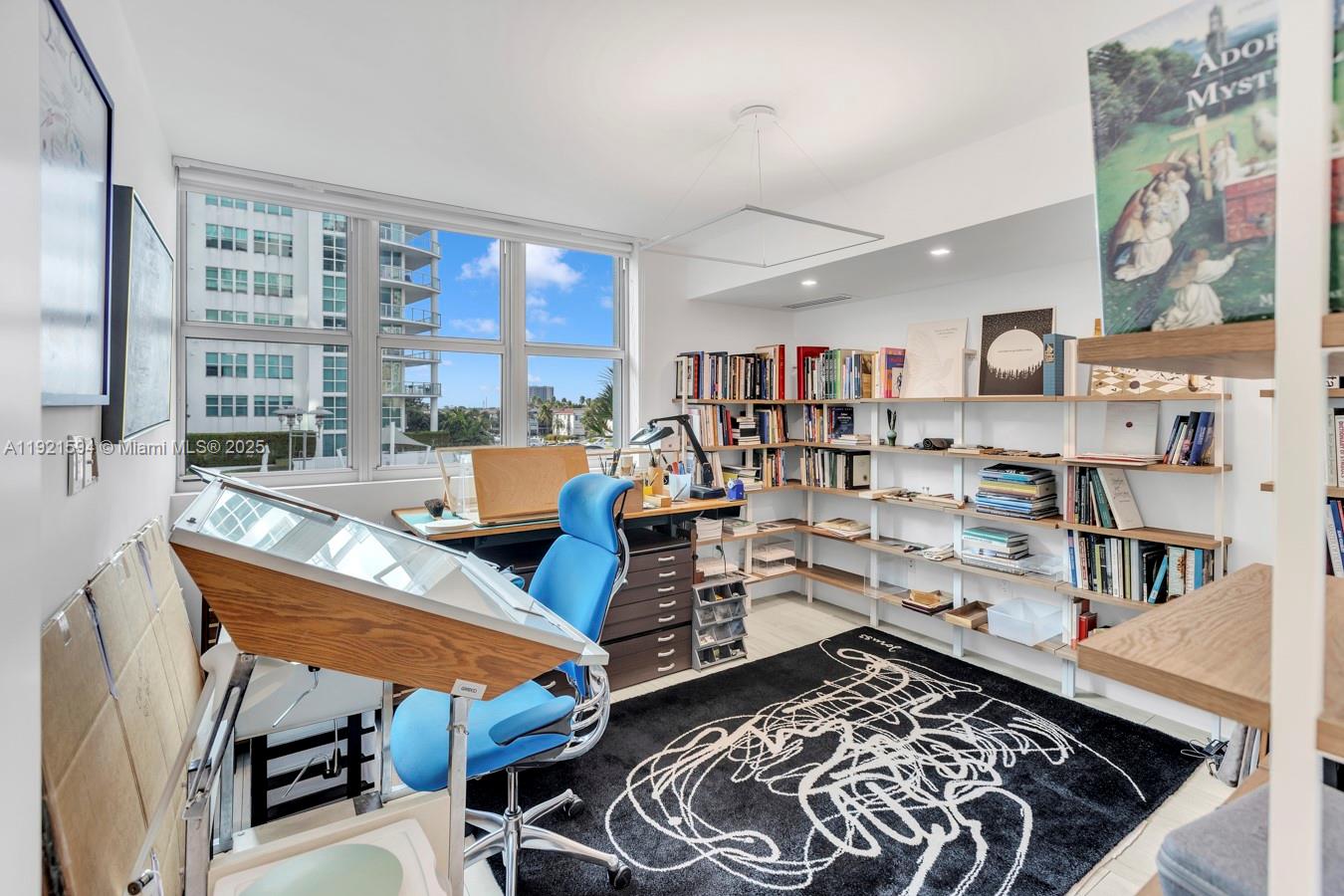 3131 Northeast 188th Street, Unit 2301 Aventura, FL 33180 - Photo 35 of 73 a bed room with furniture and a book shelf