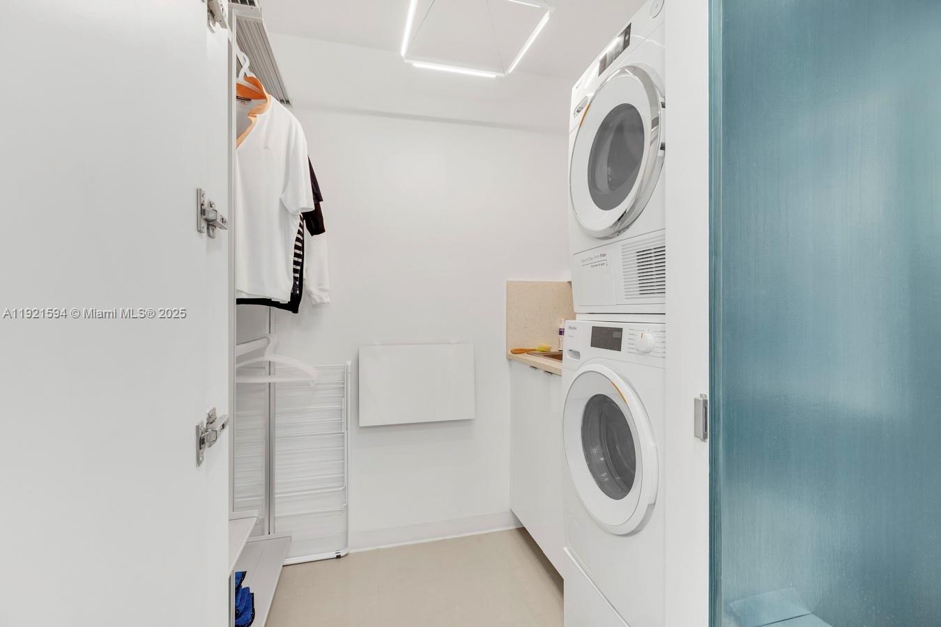 3131 Northeast 188th Street, Unit 2301 Aventura, FL 33180 - Photo 48 of 73 a utility room with dryer and washer