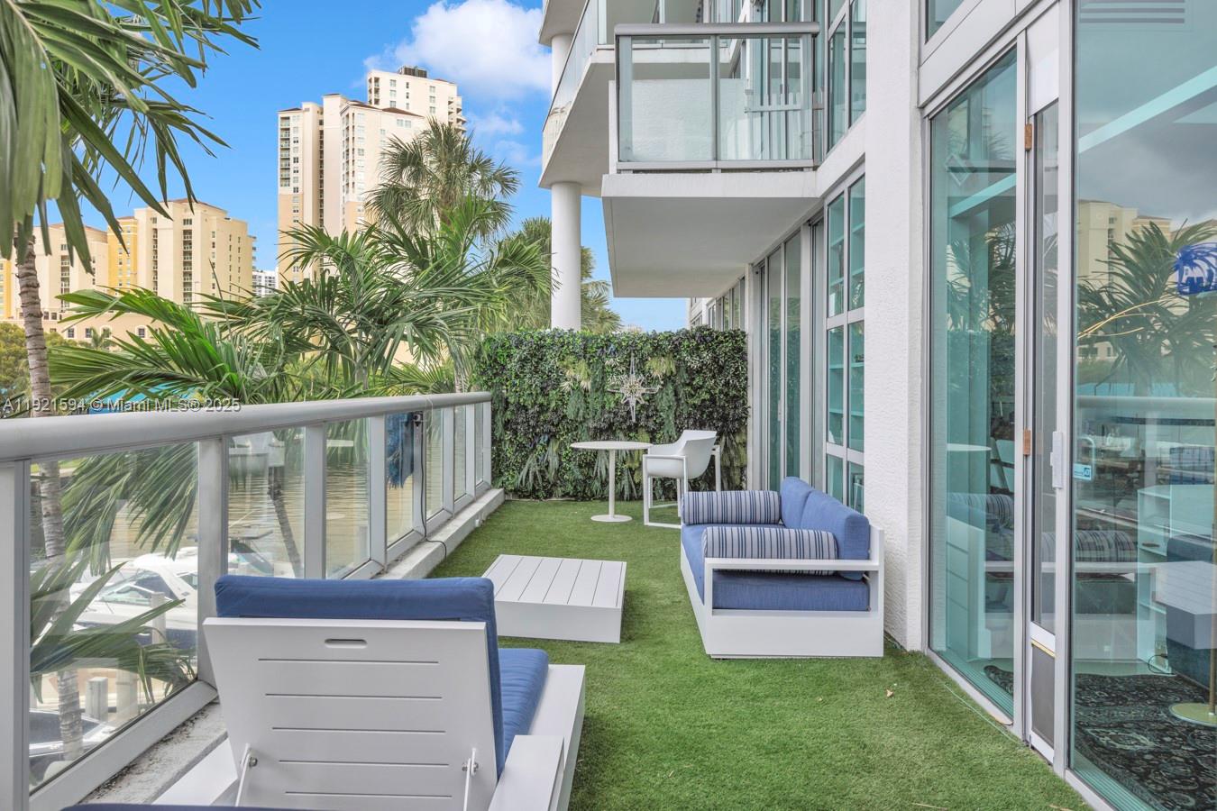 3131 Northeast 188th Street, Unit 2301 Aventura, FL 33180 - Photo 55 of 73 a view of a chair and table in the back yard