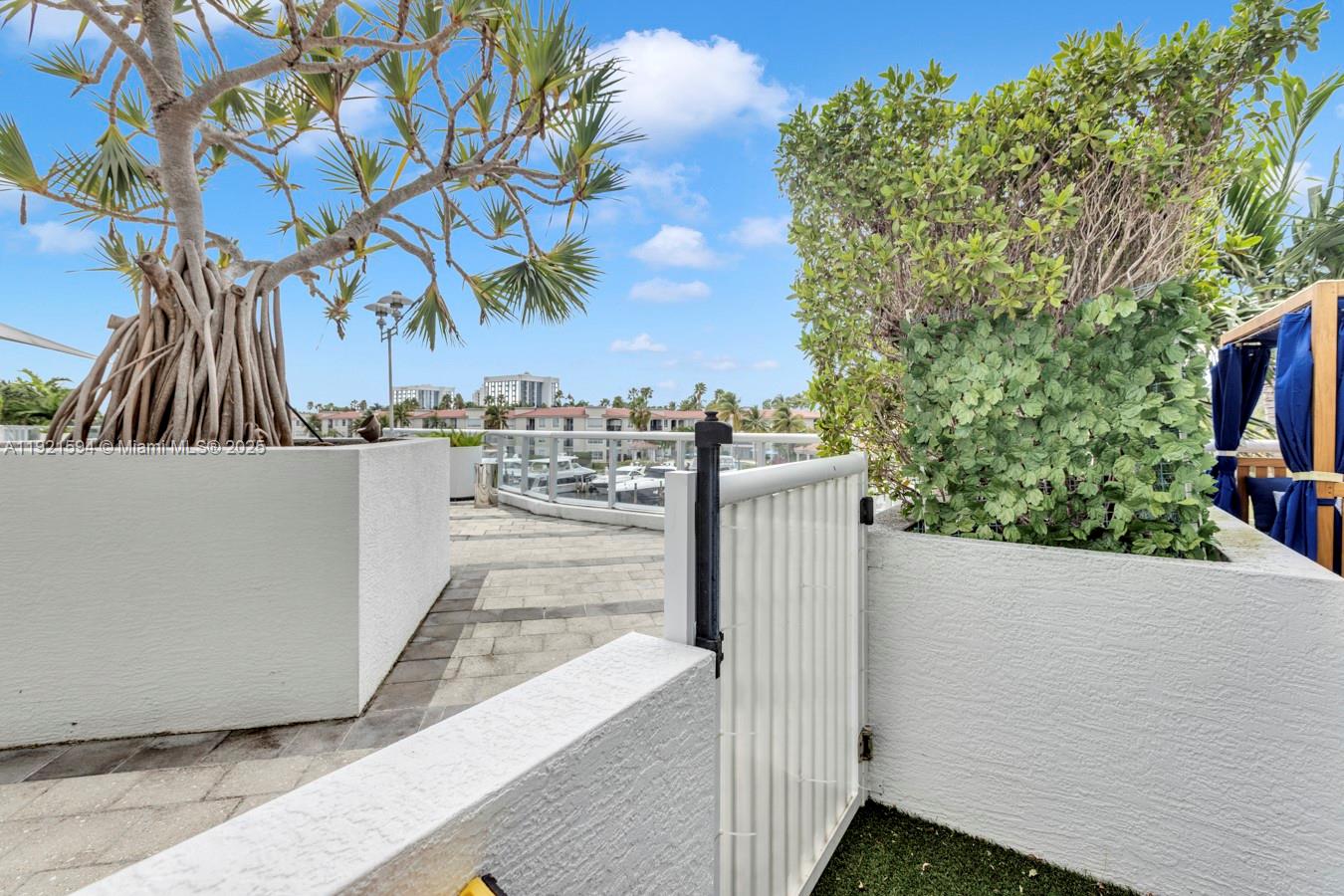 3131 Northeast 188th Street, Unit 2301 Aventura, FL 33180 - Photo 60 of 73 a view of a terrace with a tree