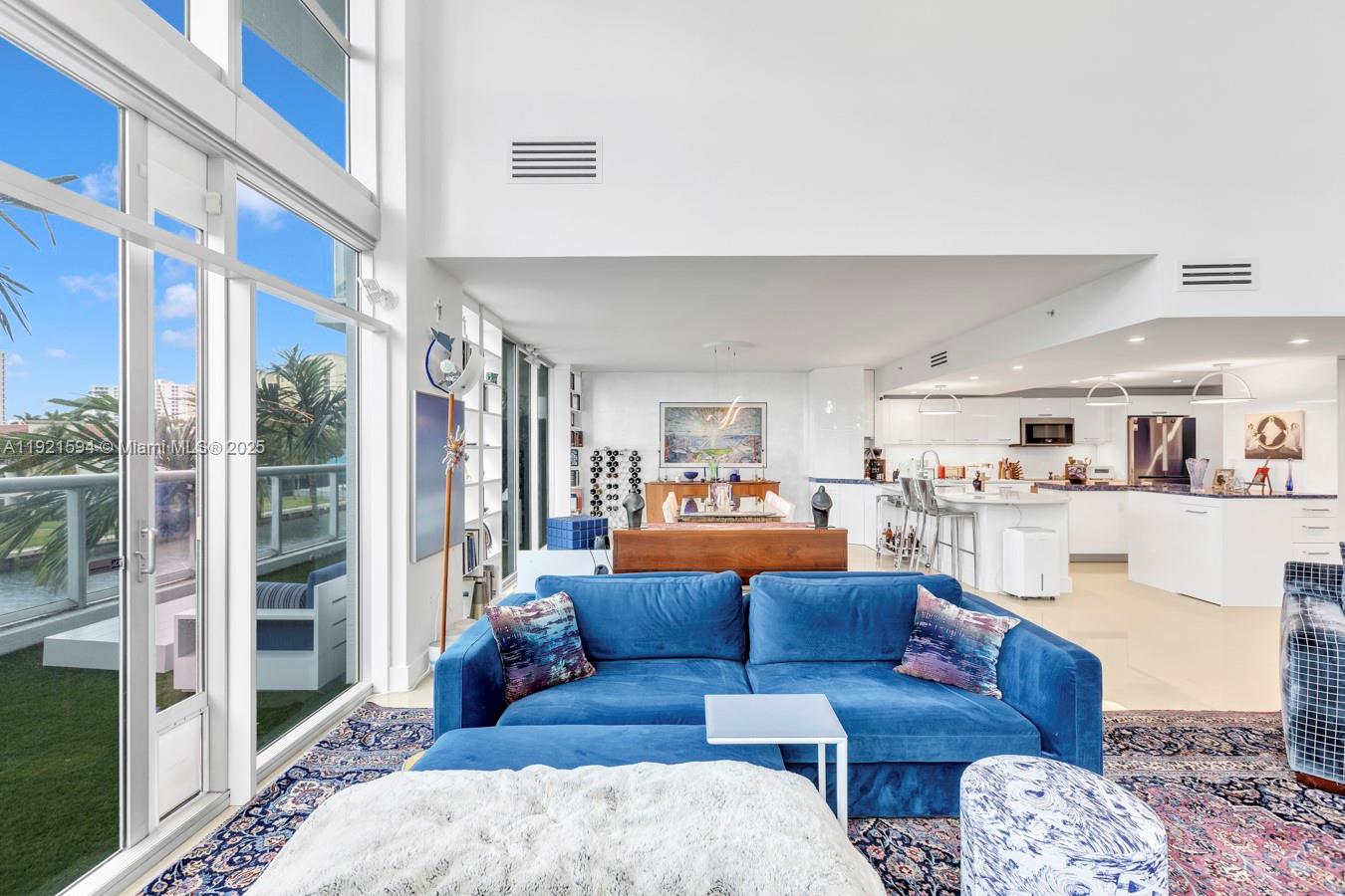 3131 Northeast 188th Street, Unit 2301 Aventura, FL 33180 - Photo 6 of 73 a living room with furniture and a book shelf