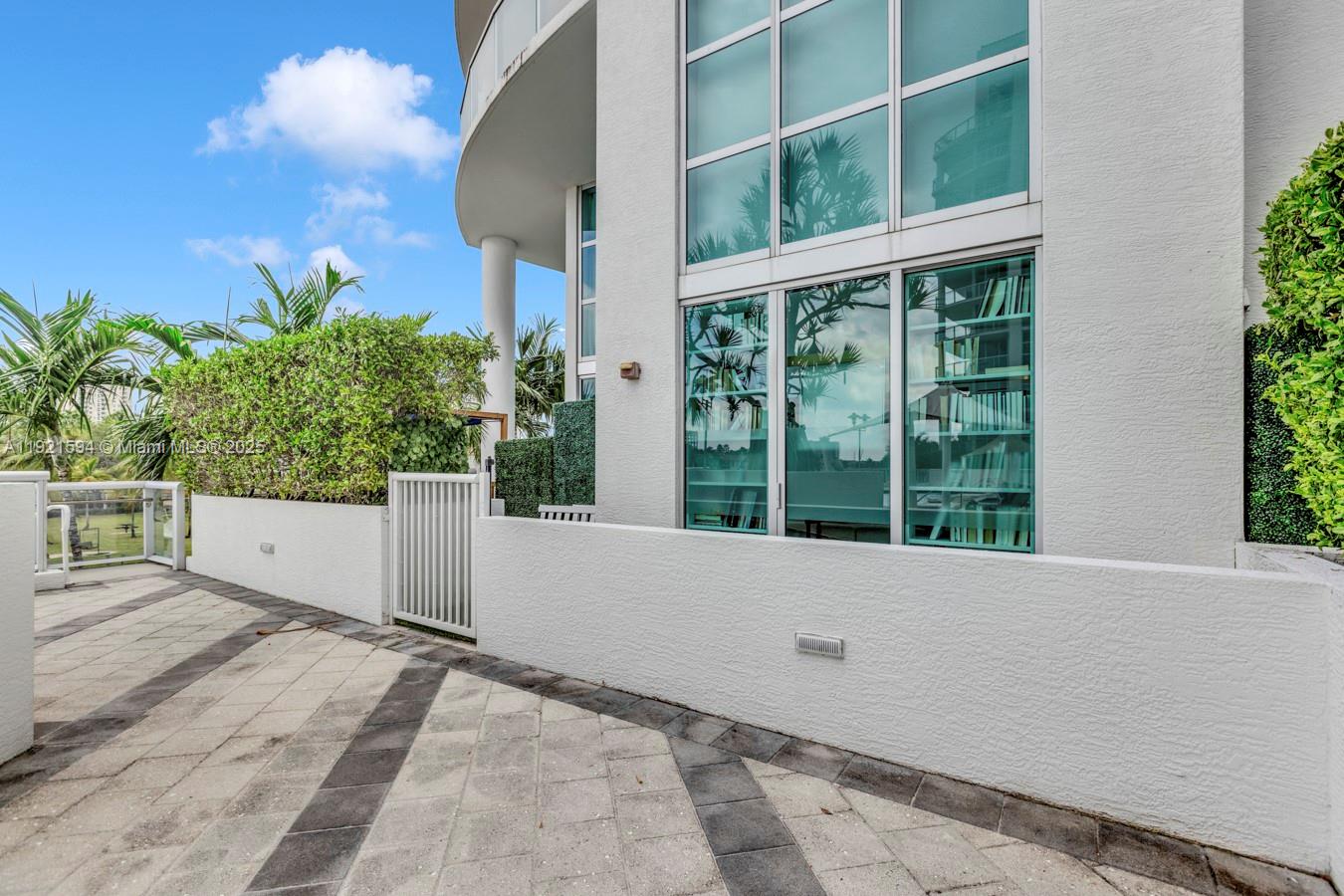 3131 Northeast 188th Street, Unit 2301 Aventura, FL 33180 - Photo 61 of 73 a view of entrance gate and garden