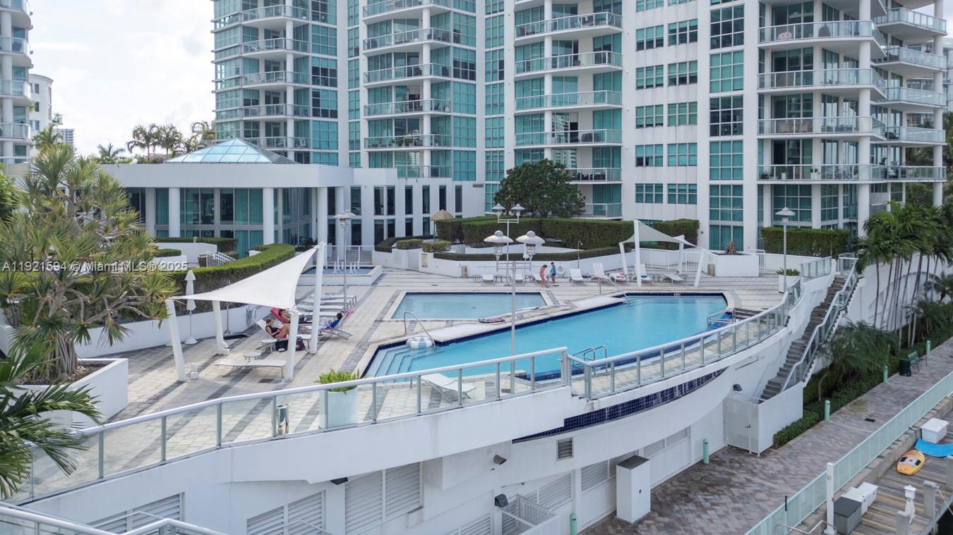 3131 Northeast 188th Street, Unit 2301 Aventura, FL 33180 - Photo 64 of 73 a view of balcony with couple of furniture and barbeque grill