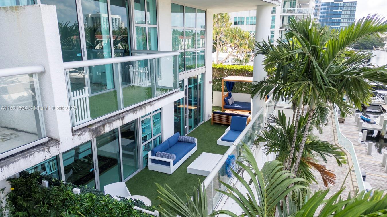3131 Northeast 188th Street, Unit 2301 Aventura, FL 33180 - Photo 70 of 73 a balcony with outdoor seating and plants