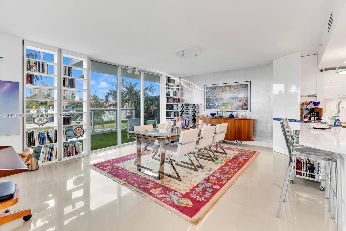 3131 Northeast 188th Street, Unit 2301 Aventura, FL 33180 - Photo 7 of 73 a living room with furniture a bookshelf and a large window