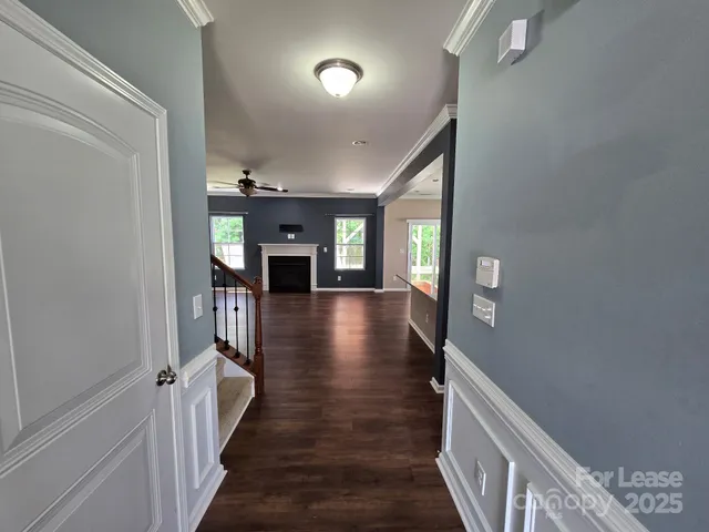a view of a hallway view with wooden floor and staircase