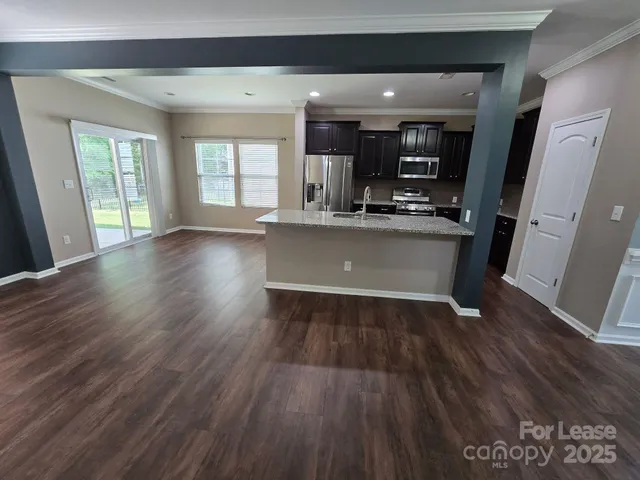 a view of kitchen with cabinets and wooden floor