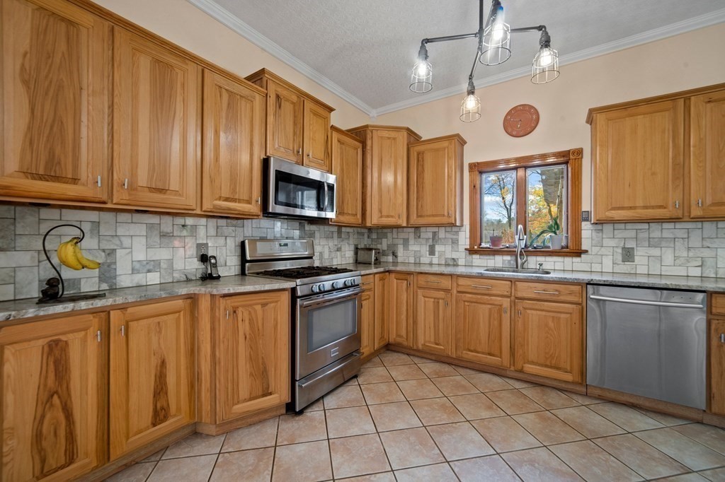 a kitchen with stainless steel appliances granite countertop a stove sink microwave and cabinets