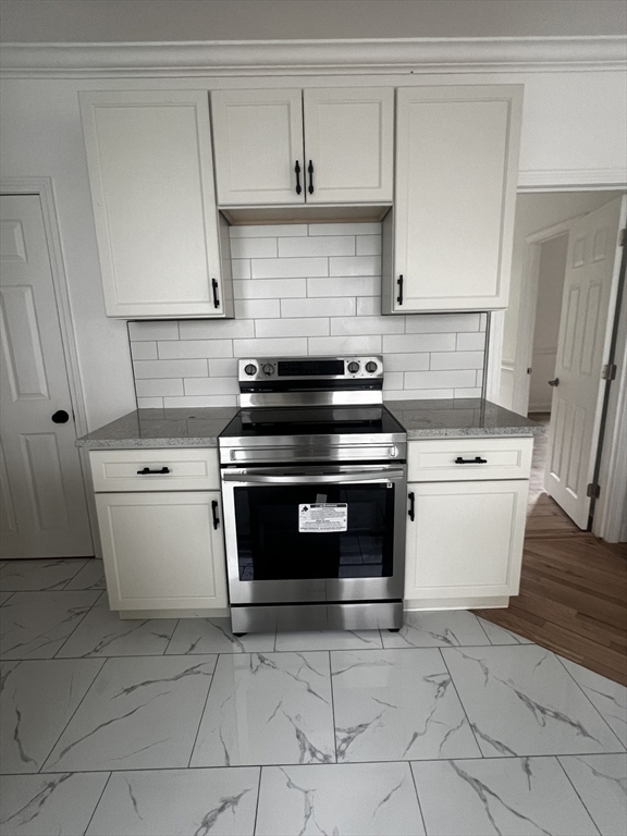 19 Reeves Street Worcester, MA 01607 - Photo 5 of 30 a white stove top oven sitting inside of a kitchen